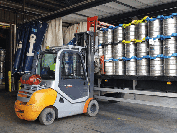 forklift truck at the side of a van retrieving a keg